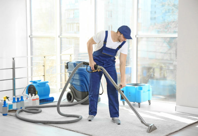 Cleaning service team working in office carpet cleaning